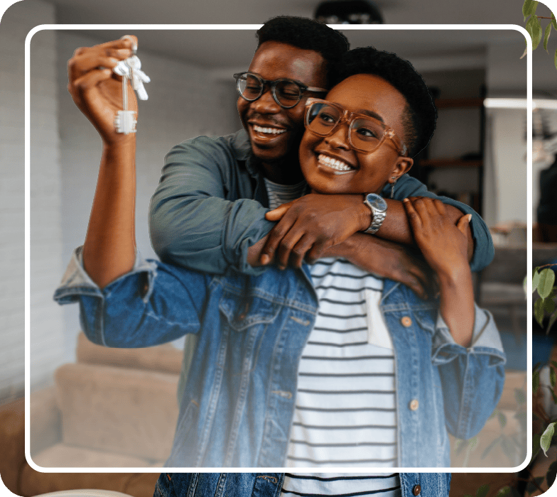 Happy couple holding the keys to their new home